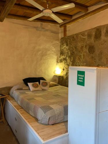 a bedroom with a bed with a green sign on it at El Jopi in Tanti