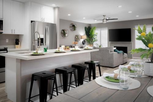 a kitchen and living room with a counter and stools at Red Mountain Retreat in Leisure World