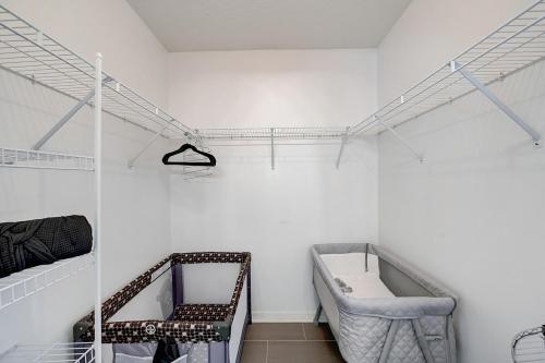 a white room with a bed and a shelf at BEST on the WEST Nr I295 DWTN Pet Frdly Games YRD in Jacksonville