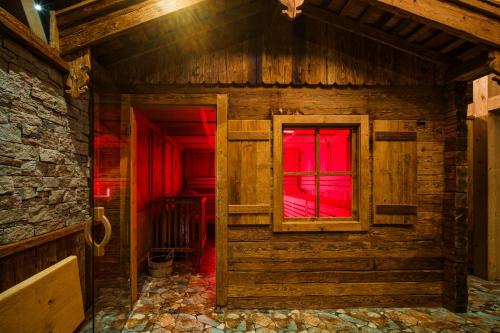 a wooden room with a window and red light at Villa Resort & Organic Spa - Halloweenská párty pro rodiny in České Budějovice