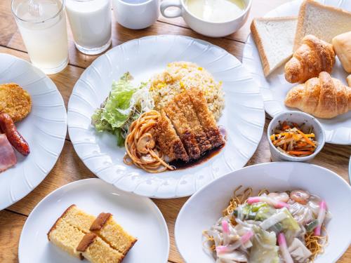 a wooden table with plates of food on it at APA Hotel Nagasaki Dejima in Nagasaki