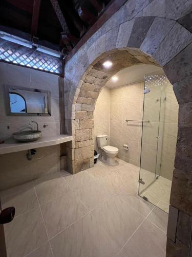 a large bathroom with a shower and a toilet at Dorado hotel boutique in Tocaima