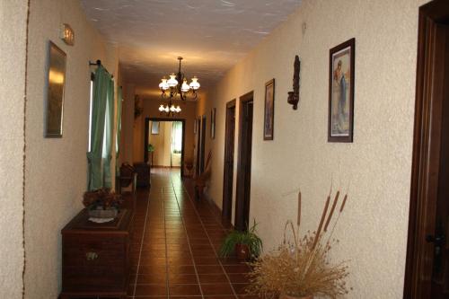 a hallway of a home with a tile floor at Hotel Restaurante Atalaya in Comares