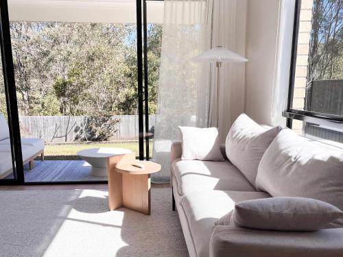 a living room with a white couch and a large window at Luxury 3-Bed Family Retreat Office Kayaks & Yard in Marsden