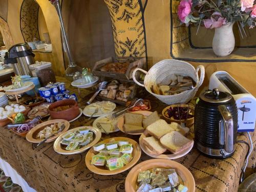 a table topped with lots of different types of food at Ksar Ouled Debbab 