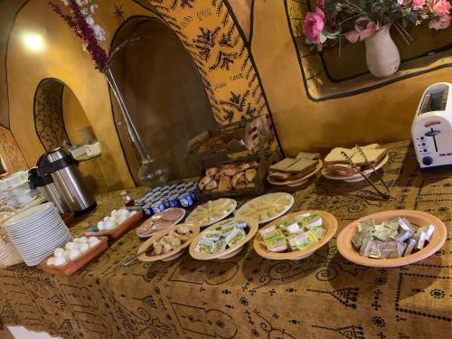 a table topped with plates of food on a table at Ksar Ouled Debbab 