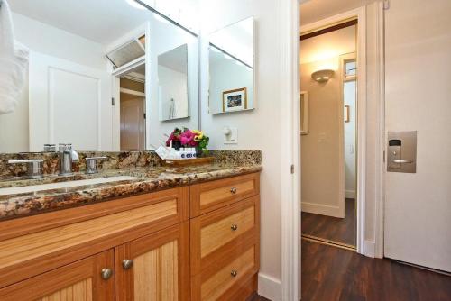 a bathroom with a sink and a large mirror at Napili Shores F246 · NS F246 Spacious Condo w Pools AC Near Napi in Kahana