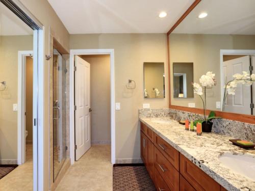 a bathroom with a double sink and a shower at Wailea Grand Champions 75 in Wailea