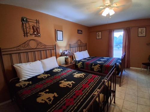 a bedroom with two beds and a window at Hill Country Lodge and Mini Storages in Buchanan Dam