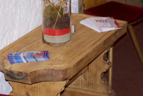 a vase sitting on top of a wooden table at Posthotel Rössli in Gstaad