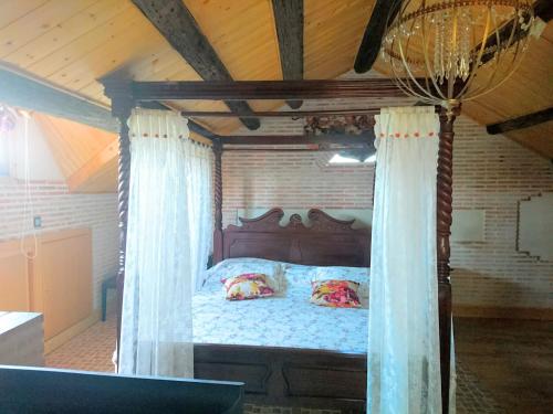 een slaapkamer met een hemelbed in een huis bij Las Rosas in Pollos
