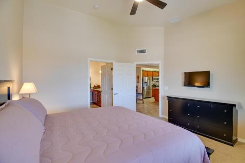 a bedroom with a large bed and a flat screen tv at 8 Mi to Tonto Natl Forest Modern Condo in Mesa! in Mesa