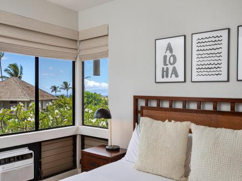 a bedroom with a bed with a view of the ocean at Wailea Grand Champions 104 in Wailea