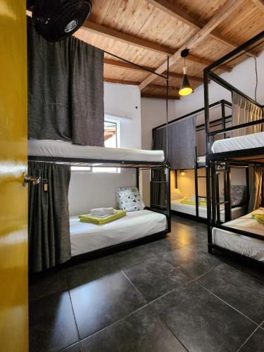 a room with three bunk beds in it at Hostel Metro Floresta Alojamiento in Medellín