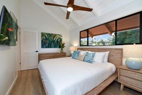 a bedroom with a large white bed and windows at Hoyochi Nikko 201 · HN 201 Relaxing Getaway OceanFront 2BD wPool in Kahana