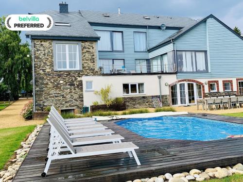 a house with a pool and a chair and a house at Holiday home in Cetturu with sauna in Cetturu