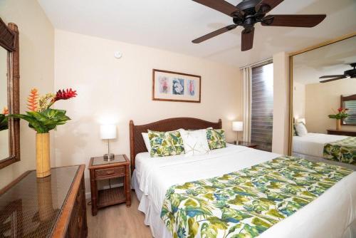 a bedroom with a bed and a ceiling fan at Kulakane 105 · KK105 Sunsets Ocean Views Oceanfront in West Maui in Kahana