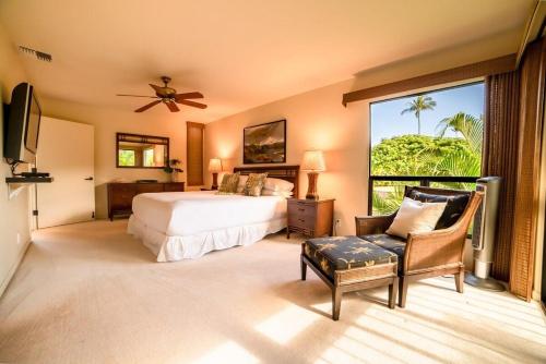 a bedroom with a bed and a large window at Wailea Ekahi 17D · WEK 17D Wailea Retreat w Ocean View Pool AC in Wailea