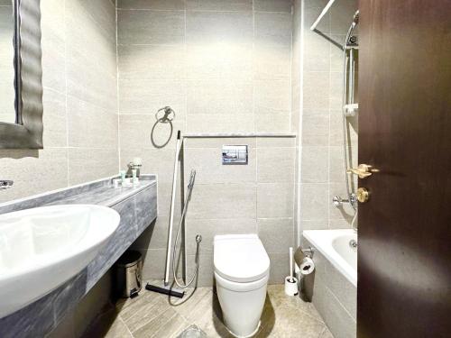 a bathroom with a white toilet and a sink at Signature Horizon Studio with Boulevard Views in Dubai