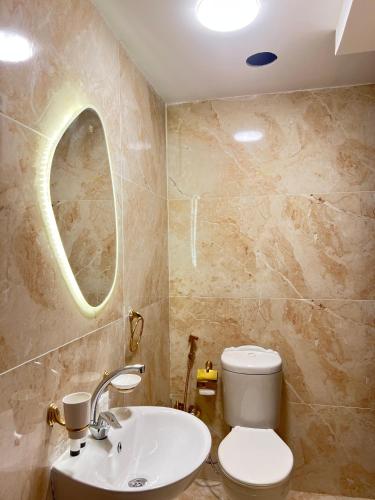 a bathroom with a sink and a toilet and a mirror at Pyramids Top view inn in Cairo