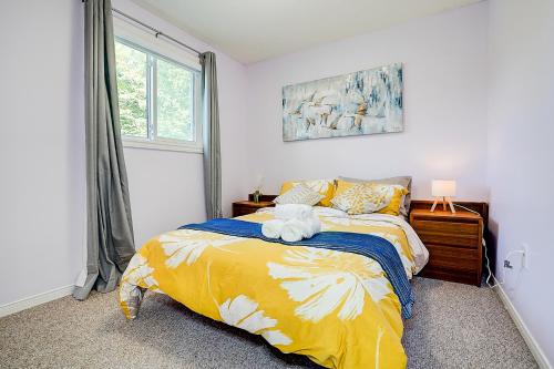 a bedroom with a bed with a stuffed animal on it at Charming Autumn Getaway Sleeps 6 Mins to Lake in Barrie