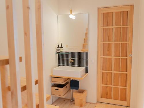a bathroom with a sink and a mirror at asterisk HIROSHIMA in Hiroshima