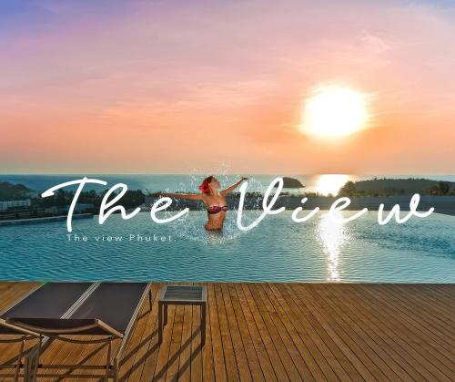 a woman is standing in the water on a boat at The View Phuket By RESAVA in Kata Beach