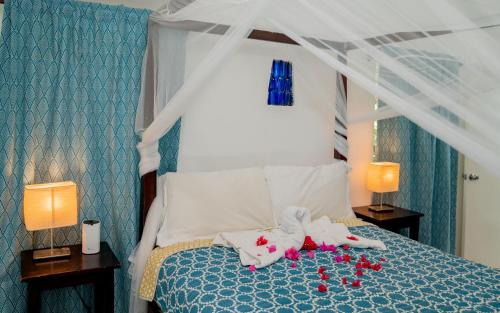 a bedroom with a bed with towels and dolls on it at Culloden Cove in Whitehouse