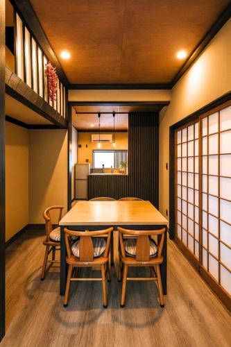 a dining room with a table and chairs at 滋庵 jian okayama in Okayama