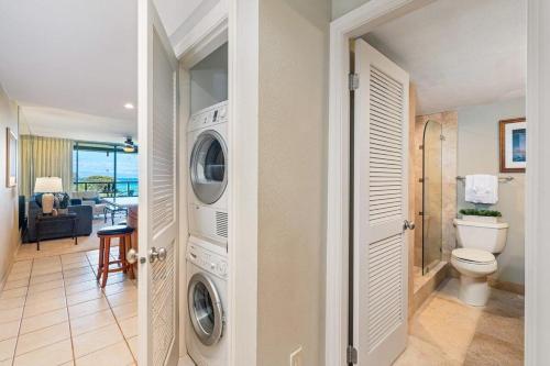 a bathroom with a washer and dryer in a house at Kahana Villa F405 · KV F405 Perfect Maui Getaway Condo w Ocean V in Kahana