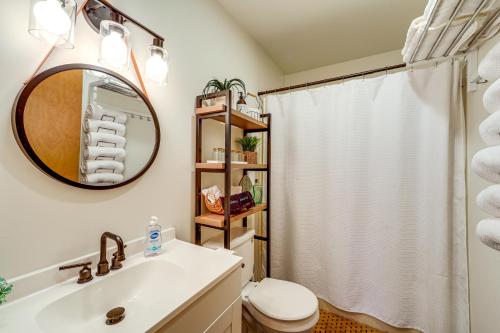 a bathroom with a sink and a toilet and a mirror at Walk to Owasco Lake Auburn Home with Hot Tub in Auburn