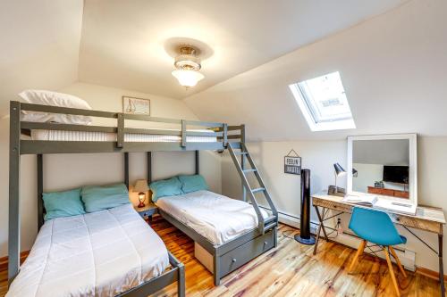 a bedroom with two bunk beds and a desk at Walk to Owasco Lake Auburn Home with Hot Tub in Auburn