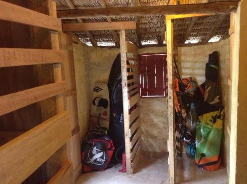 a small room with a bunch of bags in it at Caju Bangalôs in Ponta do Anel