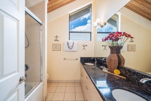a bathroom with a sink and a vase of flowers at Kahana Village 2 · KHV 2 Direct Oceanfront 2BD Condo Steps to Be in Kahana