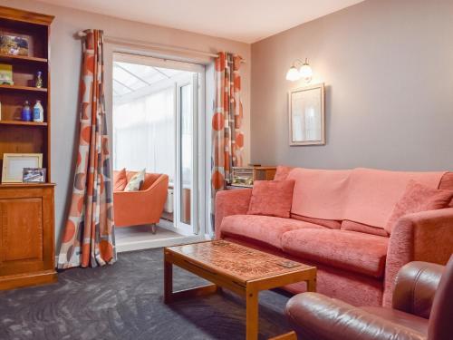 a living room with a couch and a table at Pinecote in Bottesford