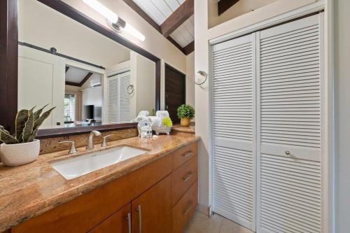a bathroom with a sink and a mirror at Wailea Ekolu 1604 · WE 1604 Wailea 2BD Condo w AC Pool Near Beac in Kihei