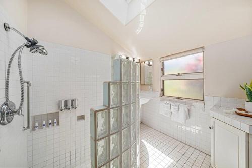 a white bathroom with a shower and a tub at International Colony Club 43 · ICC 43 Spacious 2BD Cottage Walk in Lahaina