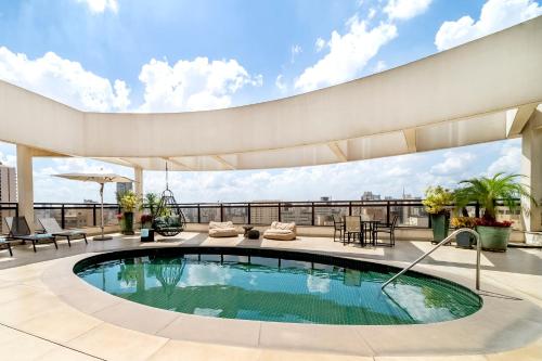 a swimming pool on the roof of a building at Grand Mercure SP Itaim Bibi in Sao Paulo