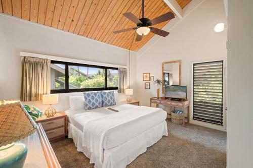 a bedroom with a white bed and a ceiling fan at Kahana Village 26 · KHV 26 2BD Direct Ocean Front with Amazing S in Kahana