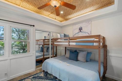 a bedroom with two bunk beds and a ceiling fan at Kihei Garden Estates G207 · KGE G207 Newly Updated 2BD Condo AC in Kihei