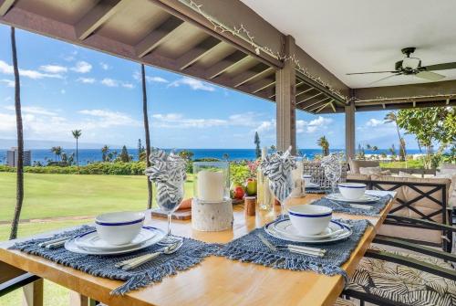 a dining table with a view of the ocean at Kaanapali Plantation 11 · Modern Luxury Near Beach in Lahaina