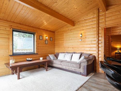 a living room with a couch and a coffee table at Mendip Lodge in Ston Easton