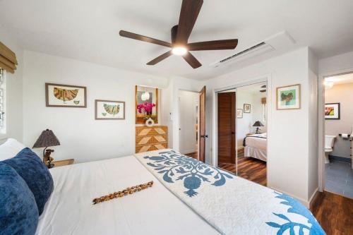a bedroom with a bed and a ceiling fan at International Colony Club 28 · ICC 28 Remodeled 2BD Cottage in K in Lahaina
