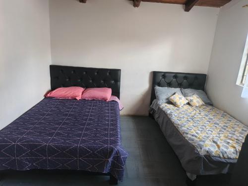 a bedroom with two beds in a room at Refugio in Hacienda Chaquibamba