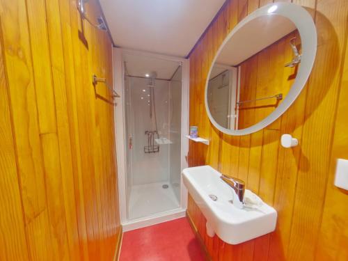 a bathroom with a sink and a mirror and a shower at Chalet au calme pour 10 pers, proche centre et activités - FR-1-834-9 in Les Rousses