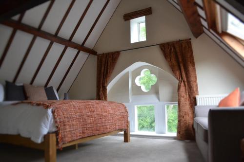 a bedroom with a bed and a large window at The School House B & B in Bucknell