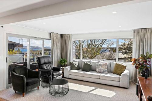a living room with a couch and two chairs at Rainbow Haven Where family time meets Lake time in Coffs Harbour
