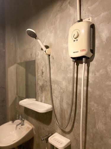 a bathroom with a shower and a sink at Rhythm of life guesthouse 56 in Bangkok