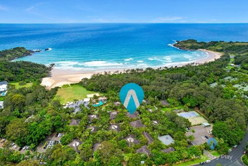 an aerial view of a beach with a large blue sign at Diggers Beach Studio in Kororo Basin