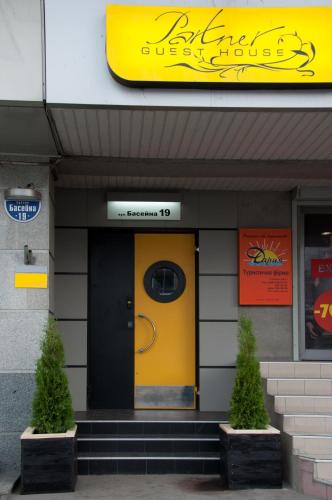 a yellow door in the front of a building at Partner Guest House in Kyiv